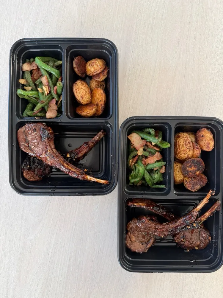 Lamb chops with roasted potatoes and green beans in meal-prep trays