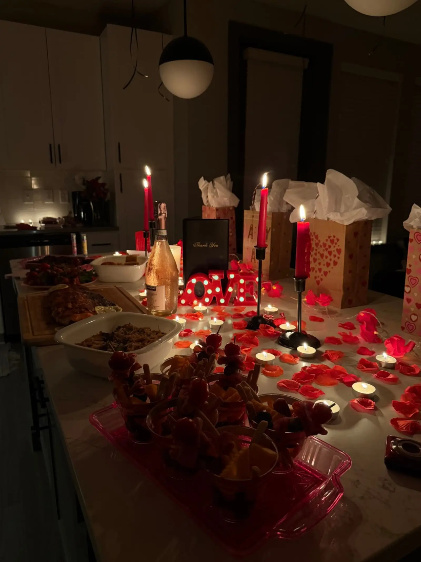 Private dinner table with candles and rose petals